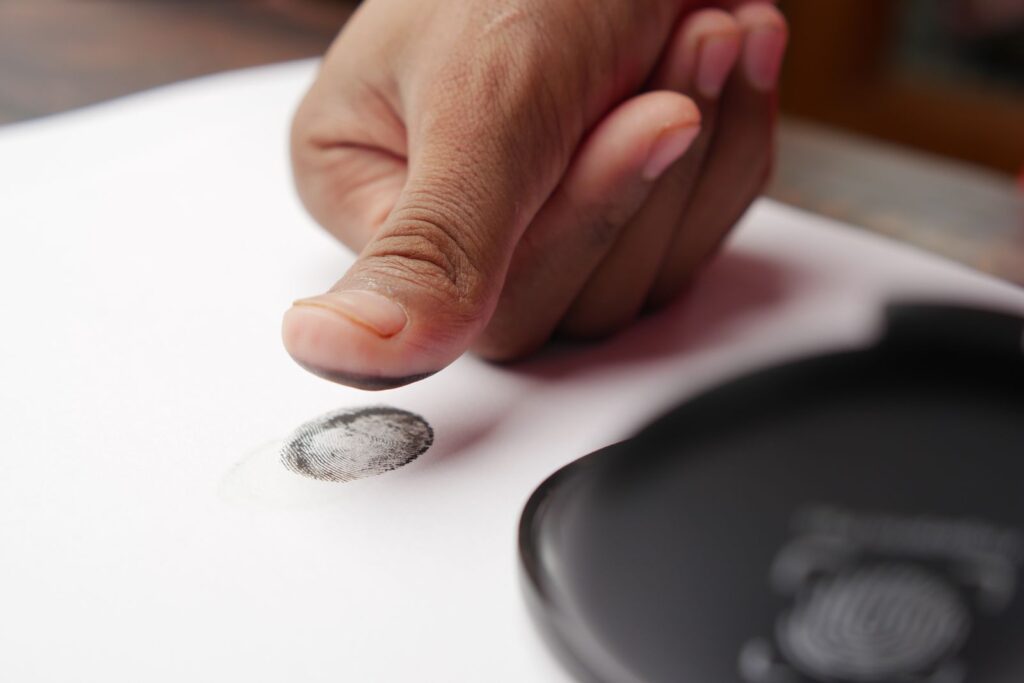 A thumb impression being made on paper